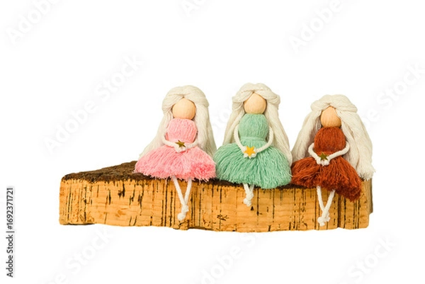 Obraz Isolated interior toy macrame dolls with long hair in the form of angels sit on a cork board.