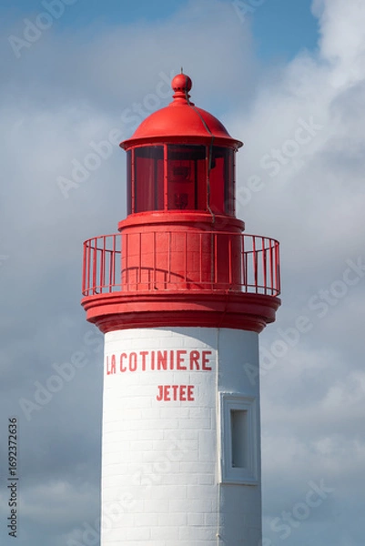 Obraz La Cotinière Lighthouse on a sunny day in summer. Beautiful red and white french lighthouse located in La Cotinière, Oléron island, Charente-Martime in France.