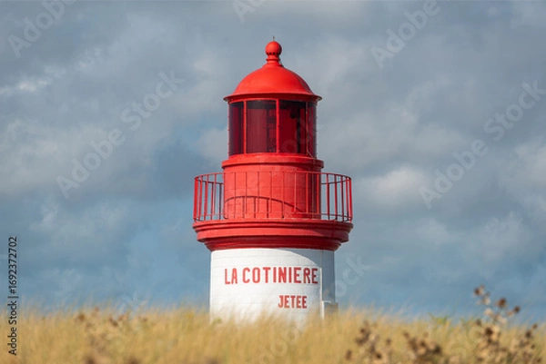 Obraz La Cotinière Lighthouse on a sunny day in summer. Beautiful red and white french lighthouse located in La Cotinière, Oléron island, Charente-Martime in France.