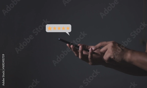 Fototapeta Review Customer, Young Man hand holding Smart Phone with five star to review and give 5 stars with very good results in service, Good review 5 star rating choice feedback