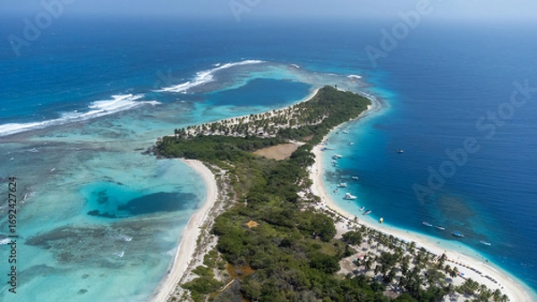 Fototapeta Stunning drone view of Morrocoy National Park in Venezuela, showing turquoise waters, coral reefs, sandy beaches, and tropical vegetation. Perfect concept for paradise, travel, and nature