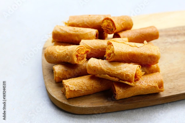 Fototapeta Rolled crispy wafers filled with shredded pork floss, Thai snack.