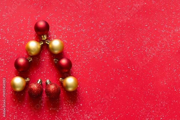 Fototapeta Christmas tree made of red and golden Christmas balls on a red snowy background