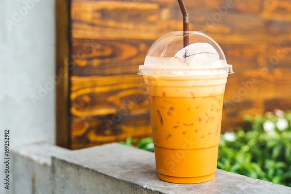 Obraz Cold iced Thai Tea, wooden background
