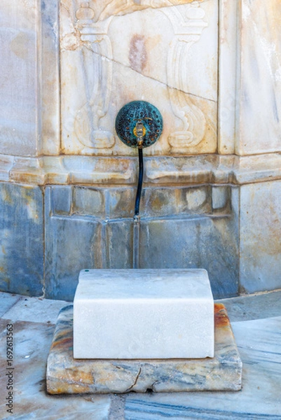Fototapeta Decorative faucet of the well where people wash their feet before entering the Al Jazzar Mosque in Acre, Akko's old city on a sunny day.
