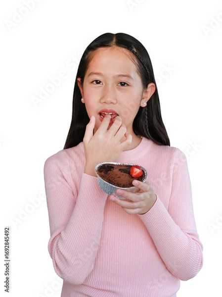 Fototapeta Asian girl child eating chocolate cake by index finger isolated on white background. Image with clipping path.