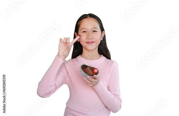 Fototapeta Portrait of Asian pretty girl show chocolate cake on index finger isolated on white background. Image with clipping path.