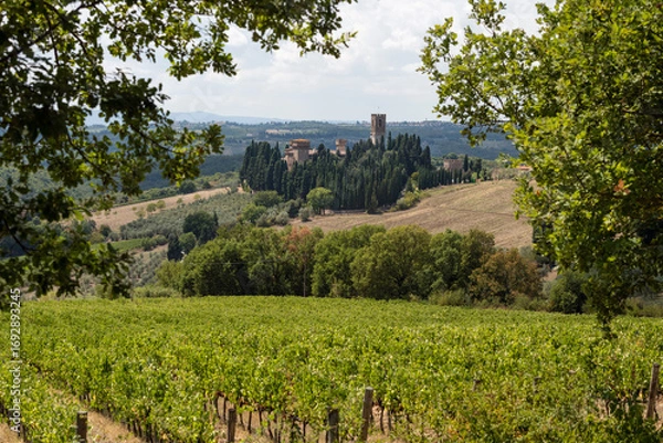 Fototapeta Badia di Passignano, Abbey of San Michele Arcangelo Passignano is historic Benedictine abbey located atop hilltop, surrounded by cypresses in Tuscany. Italy