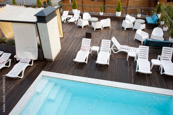 Fototapeta Recreation complex with sun loungers and a swimming pool.