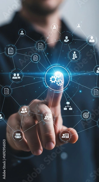 Fototapeta Businessman touching a digital network of interconnected icons representing business processes and people