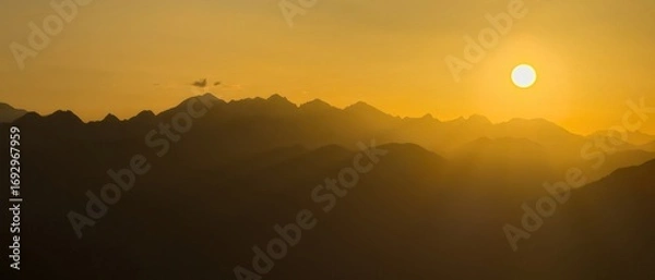 Fototapeta Pyrenees mountains during golden hour sunset creating stunning vista.