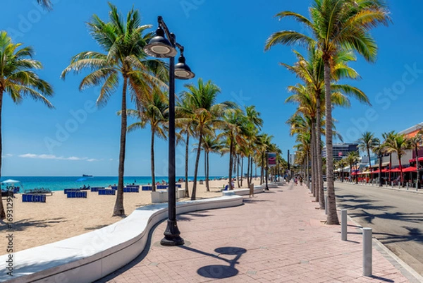 Fototapeta Seafront promenade and wonderful beach with palm trees on a sunny summer day in Fort Lauderdale, Florida.