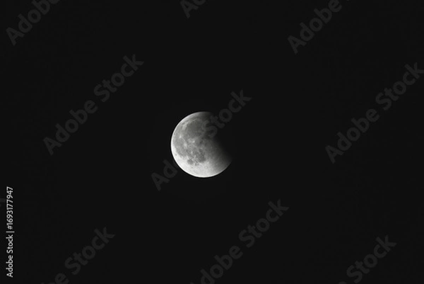 Fototapeta Close-up of the moon during a lunar eclipse against a dark night sky.