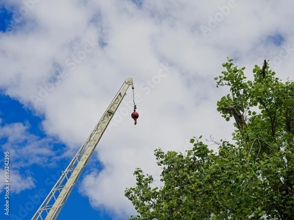 Obraz Construction crane hook set against blue sky