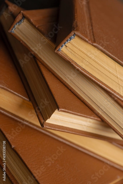 Fototapeta fragment of a stack of old books for background