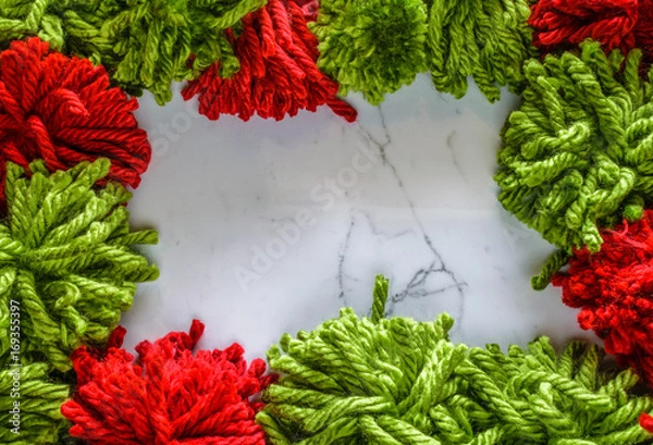 Fototapeta Red and Green yarn frame a marble background.  DIY project.  Handmade Concept.