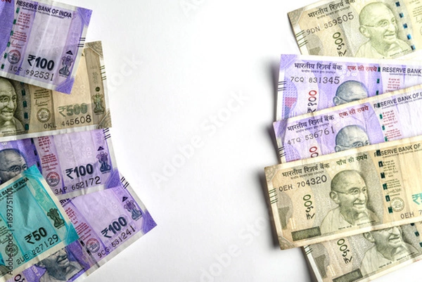 Fototapeta Various Indian Rupee Notes Arranged Against a Clean White Background