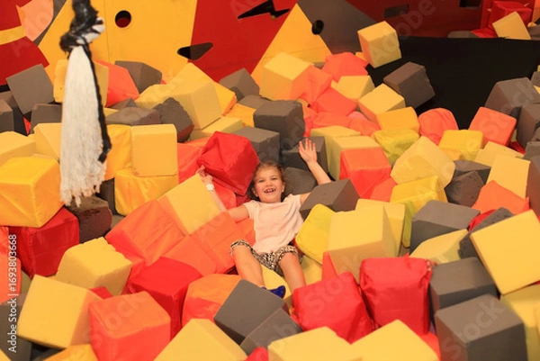 Fototapeta Happy Child in Foam Pit at an Entertainment Center