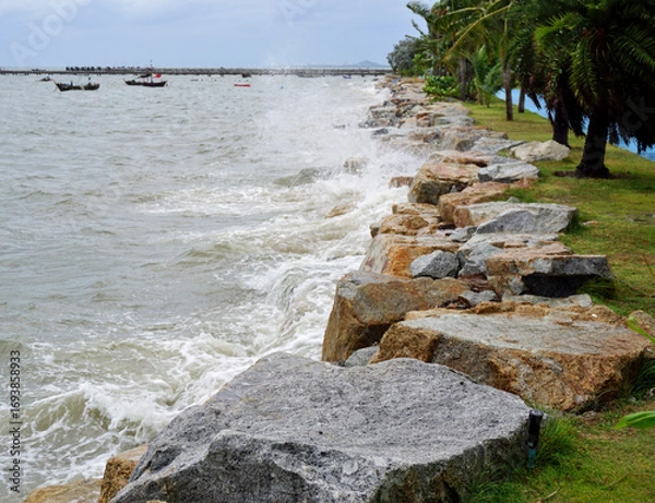 Obraz Splashing sea surf hitting rocks on the beach