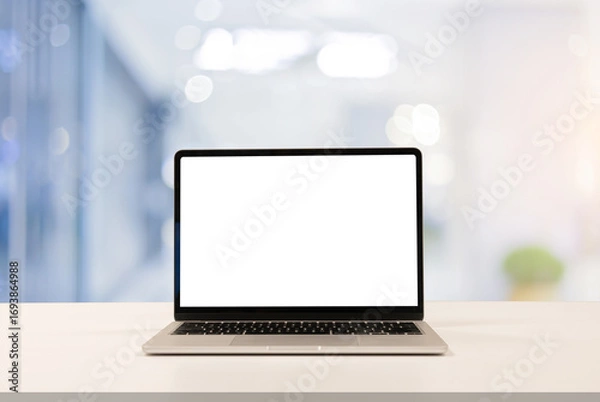 Fototapeta close up isolated on blank white screen display of laptop computer on table inside office room for add content of design banner , website or template or online shopping e-commerce concept