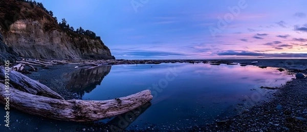 Fototapeta Peaceful coastal dusk with glassy water mirroring pink and purple clouds (Nature Scenery)