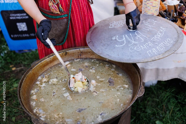 Fototapeta Experience Traditional Cooking in a Cozy Rustic Setting, Enjoying Delicious Hearty Soup