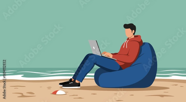 Fototapeta Young man working remotely on a laptop while relaxing on a bean bag on a sandy beach. Represents modern flexible work, digital nomad lifestyle, and travel productivity.
