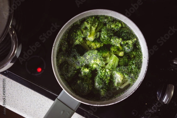 Obraz Cooking broccoli in a pot on the stove