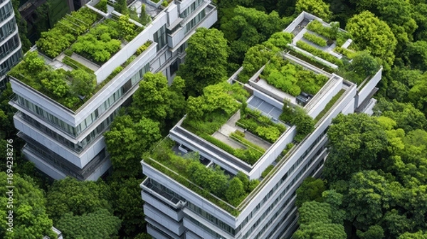 Fototapeta Modern eco friendly buildings with green roofs surrounded by lush trees create harmonious urban environment