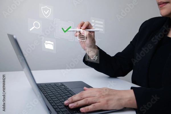 Fototapeta Digital document verification concept as businesswoman uses stylus to interact with virtual checklist interface, illustrating secure approval, workflow automation, and online data validation.