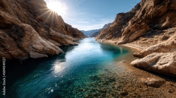Fototapeta A stunning view of a tranquil river weaving through rocky cliffs under sunlight, highlighting the serene beauty of nature and the peaceful solitude of wilderness.