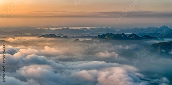 Fototapeta Mountain Peaks Emerging Through Sea of Clouds at Sunrise, Yichang China Misty Landscape