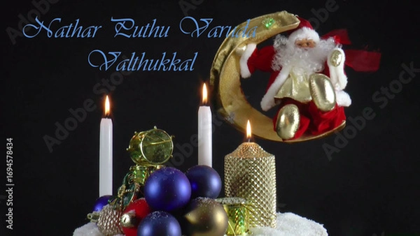 Fototapeta Warm Wishes for Christmas Joy 
A festive card with candles, baubles, and Santa Claus in the language 
