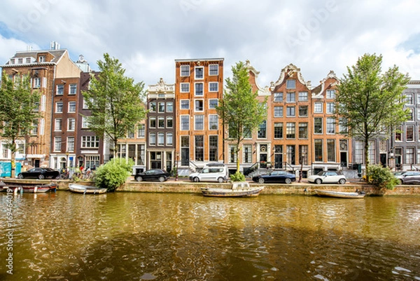 Obraz View on the beautiful old buildings and water channel in Amsterdam city
