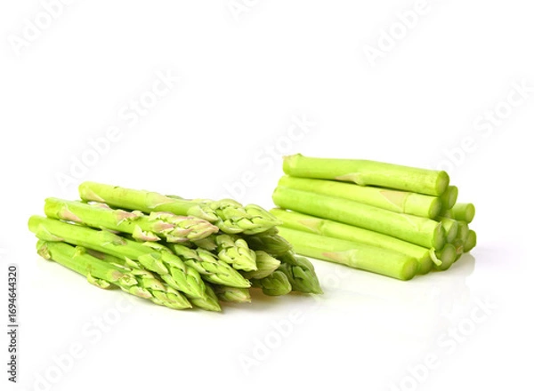 Fototapeta pile of ripe green asparagus , Fresh sprouts of asparagus isolated on white background.