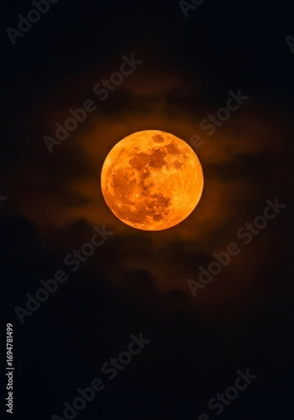 Obraz Fiery Orange Full Moon Rising Through Night Clouds
