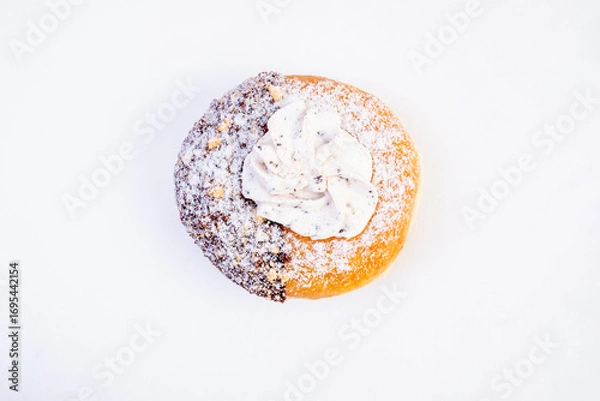 Fototapeta Donut with powdered sugar. One half is coated with chocolate and the other half remains plane with a golden glaze.