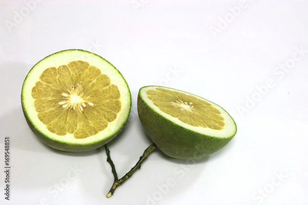Fototapeta The two sliced pomelo are on white background.They are a kind of grapefruit and a dilicious thai fruit. 