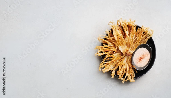 Fototapeta Fried Enoki Mushrooms with sauce on concrete background, top view
