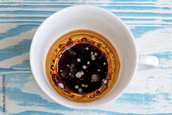Fototapeta This is an image of a cup of coffee with a layer of cream or milk on top