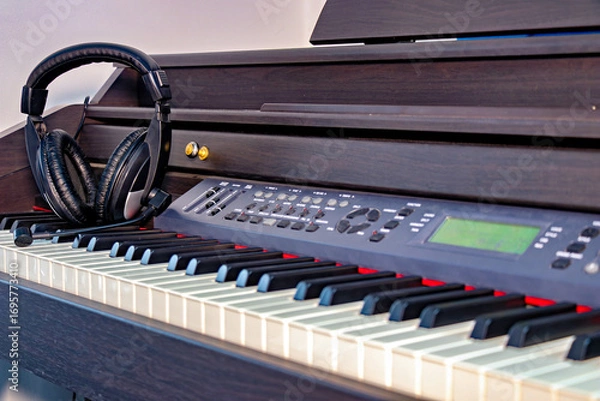 Fototapeta This image shows a musical keyboard which appears to be an electric piano or keyboard placed on a piano