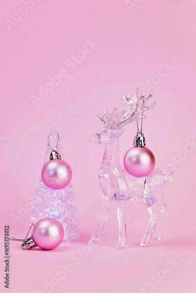 Fototapeta Christmas card on which a beautiful transparent Christmas tree is decorated with pink balls by a transparent deer, pink background, vertical, creative focus