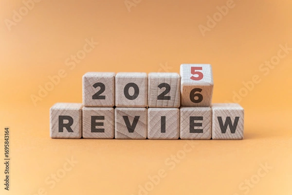 Fototapeta Flipping of 2025 to 2026 on wooden blocks. 2025 business and customer review for business strategic planning in the next year 2026. End of the year business concept.
