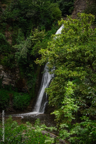 Obraz Hidden Waterfall Surrounded by Dense Green Forest