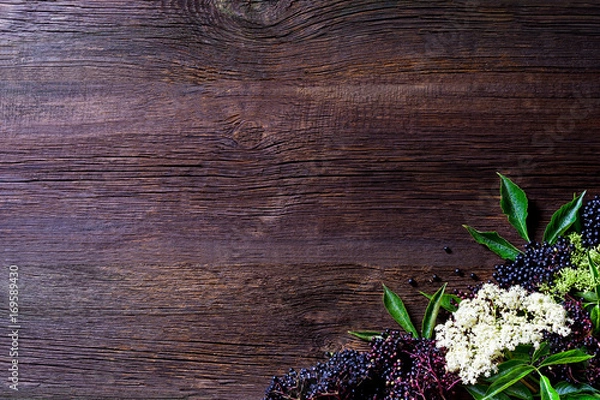 Fototapeta Toasts with elderberry jam and fresh berry fruits on wooden table. Free space for your text.