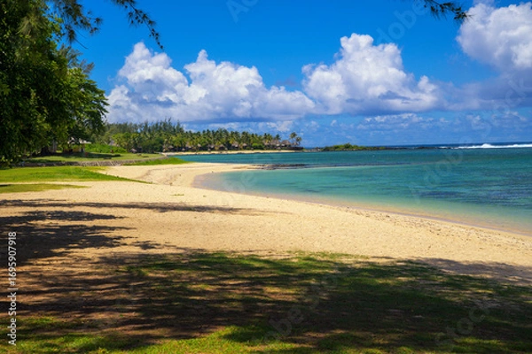 Fototapeta Clear turquoise water and white sandy shoreline at St. Felix Public Beach in southern Mauritius.