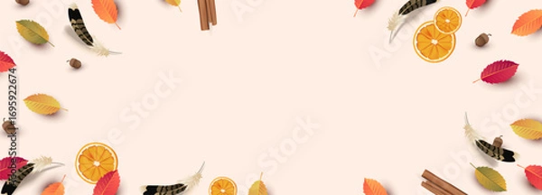 Fototapeta Autumn thanksgiving background with colorful leaves orange slices feathers acorns and cinnamon sticks with empty copy space for seasonal design and festive use