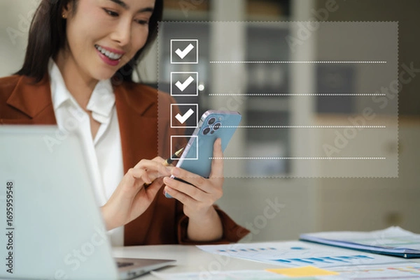 Fototapeta Businesswoman using tablet to do online checklist survey, doing assessment online survey answer test questions Digital form.
