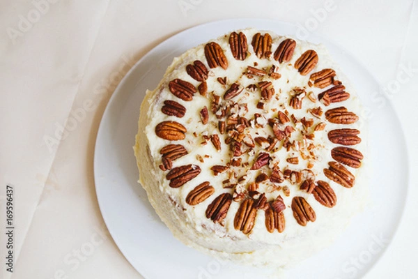 Fototapeta Hummingbird cake with pecans and cream cheese frosting