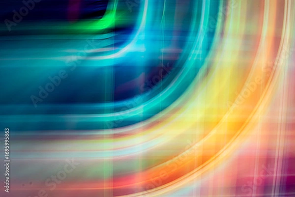 Fototapeta A digital abstract art piece featuring vibrant, overlapping yellow and orange light trails forming fluid, curving lines against a dark, blurred background.